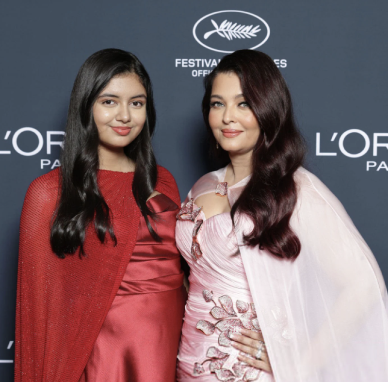 Aaradhya Bachchan Steals Spotlight at Cannes 2026 in Stunning Red Gown Alongside Aishwarya Rai decoding=